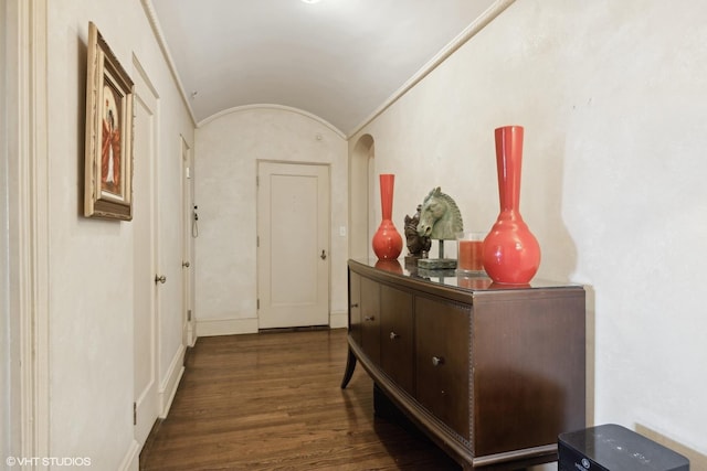 hallway featuring crown molding, lofted ceiling, and dark hardwood / wood-style flooring