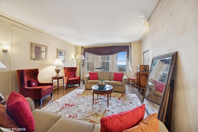 living room with wood-type flooring and ornamental molding