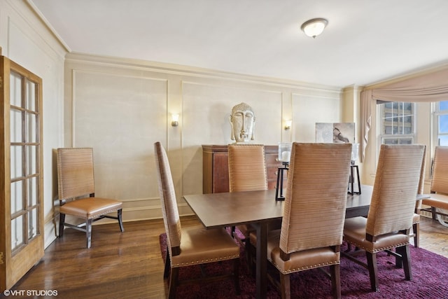 dining space featuring dark wood-type flooring and ornamental molding