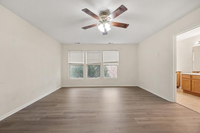 unfurnished room with hardwood / wood-style flooring and ceiling fan