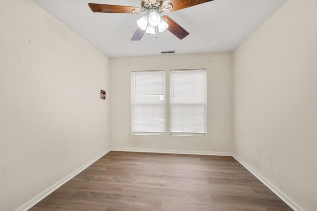 empty room featuring wood-type flooring and ceiling fan