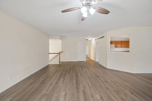 unfurnished living room with ceiling fan and light hardwood / wood-style floors