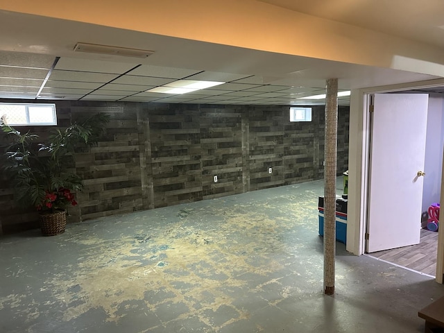 basement featuring a paneled ceiling