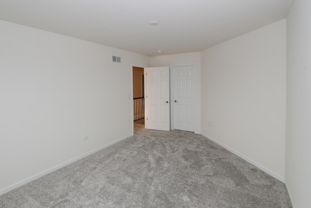 unfurnished room with light colored carpet