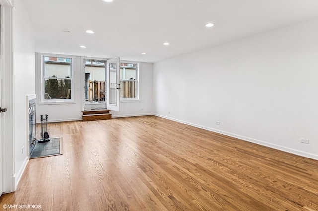 unfurnished living room with light wood-style floors, baseboards, and recessed lighting