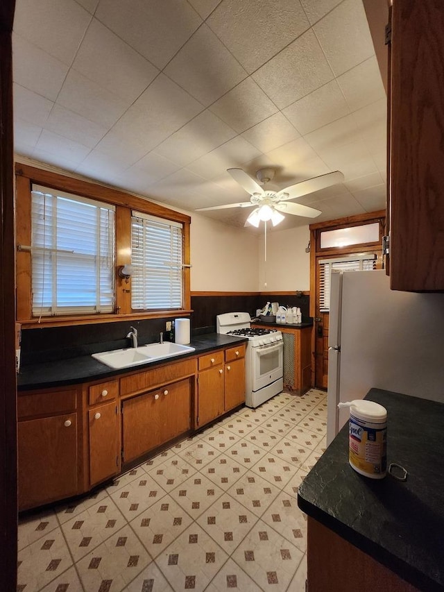 kitchen with ceiling fan, white appliances, and sink