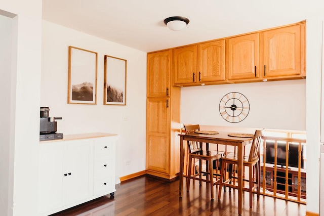 dining space featuring dark hardwood / wood-style floors