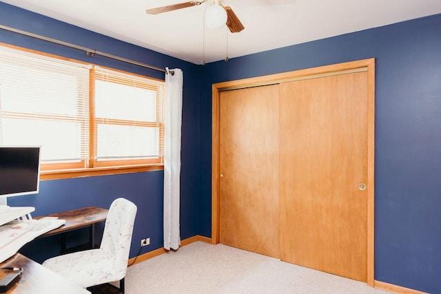 carpeted home office featuring ceiling fan