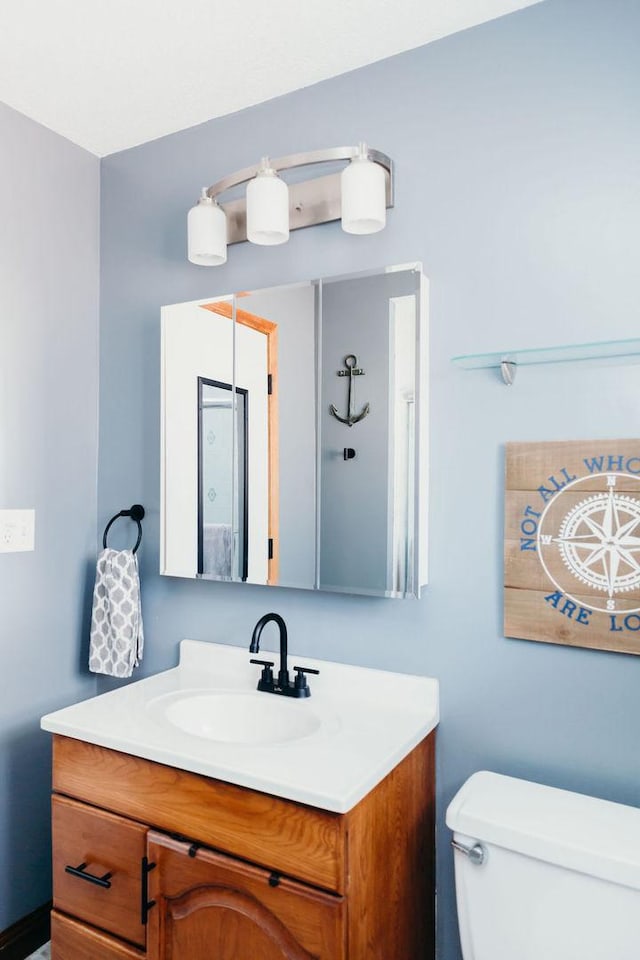 bathroom featuring vanity and toilet