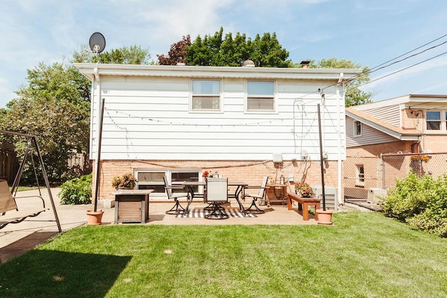 back of house featuring a yard and a patio