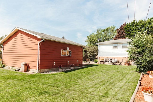 back of property with a patio area and a lawn