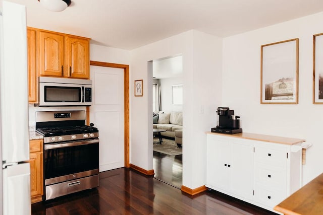 kitchen with dark hardwood / wood-style floors and appliances with stainless steel finishes