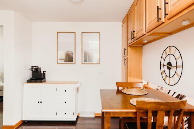 dining area featuring dark hardwood / wood-style flooring