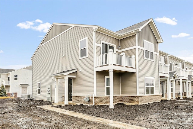 view of side of property with a balcony and cooling unit