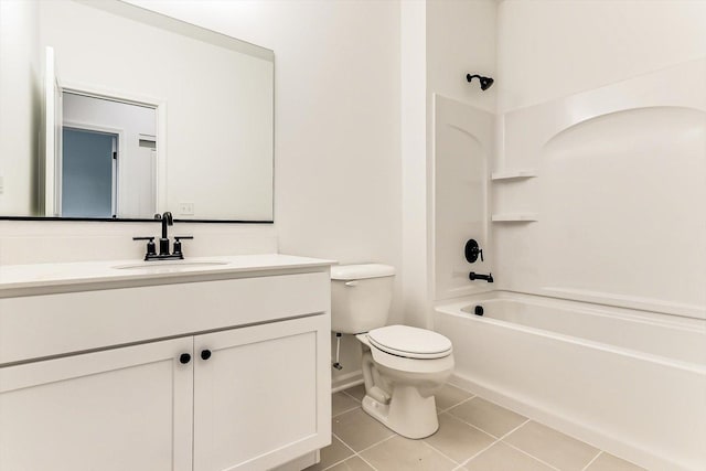 full bathroom featuring washtub / shower combination, tile patterned floors, toilet, and vanity