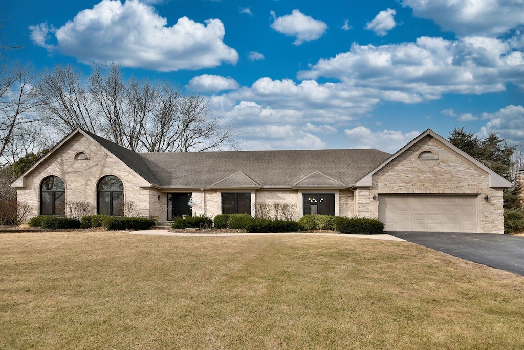 view of front of home with a garage and a front yard