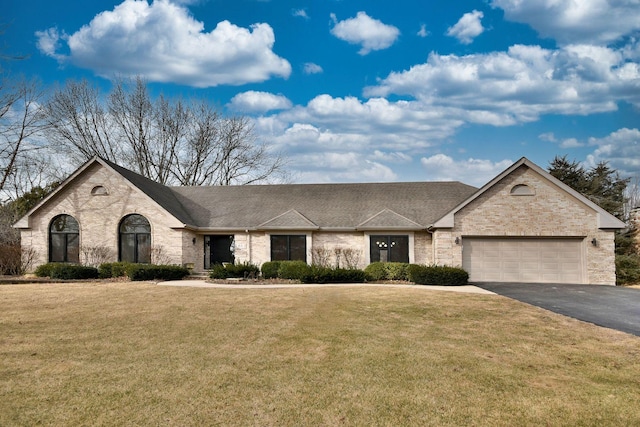 view of front of home with a garage and a front yard