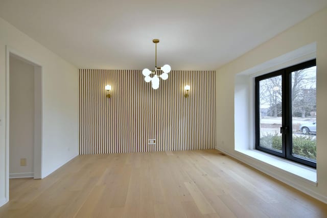 interior space with a chandelier and light hardwood / wood-style flooring