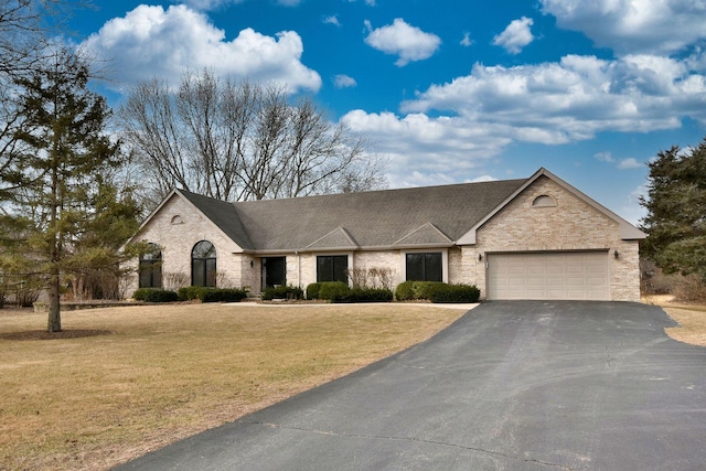 view of front of house with a garage and a front lawn