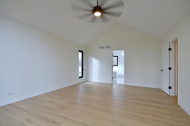 empty room featuring light hardwood / wood-style flooring, high vaulted ceiling, and ceiling fan