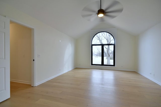 spare room with vaulted ceiling, ceiling fan, and light hardwood / wood-style floors