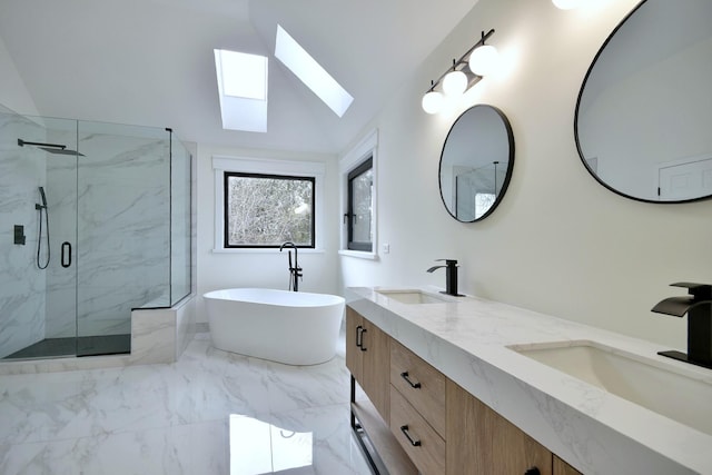 bathroom featuring vanity, lofted ceiling with skylight, and independent shower and bath