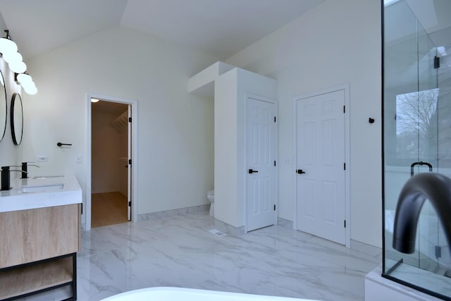 bathroom featuring vanity, vaulted ceiling, and toilet