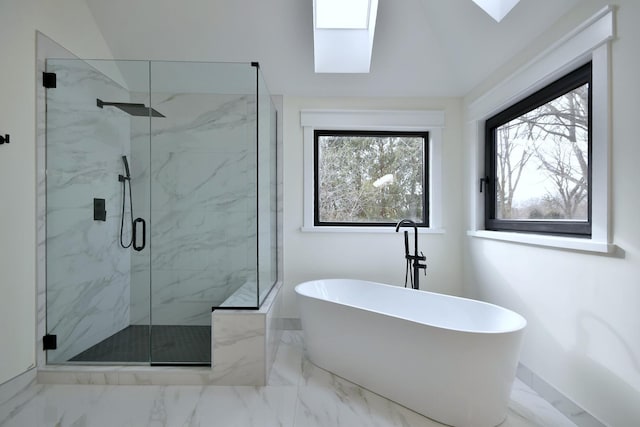 bathroom with a skylight and shower with separate bathtub