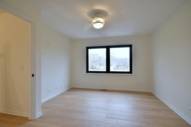 spare room with light hardwood / wood-style flooring