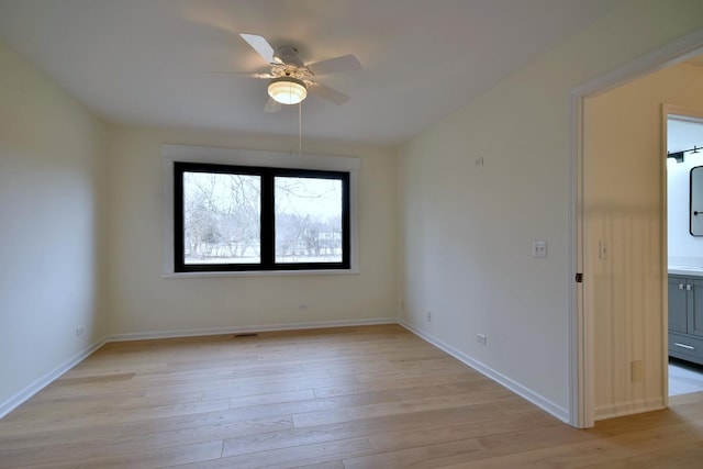 unfurnished room featuring ceiling fan and light wood-type flooring