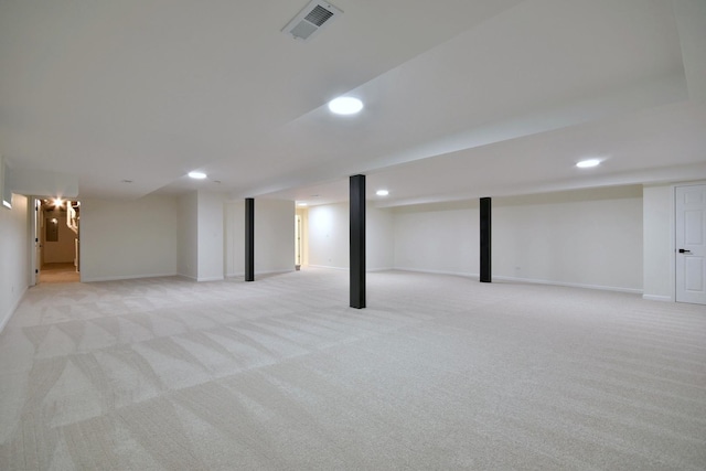 basement featuring light carpet