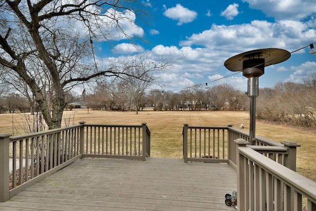 wooden terrace featuring a rural view and a yard