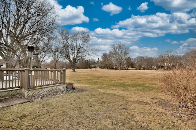 view of yard with a deck and a rural view