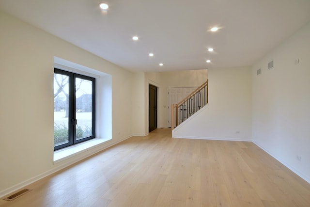 empty room with light hardwood / wood-style flooring