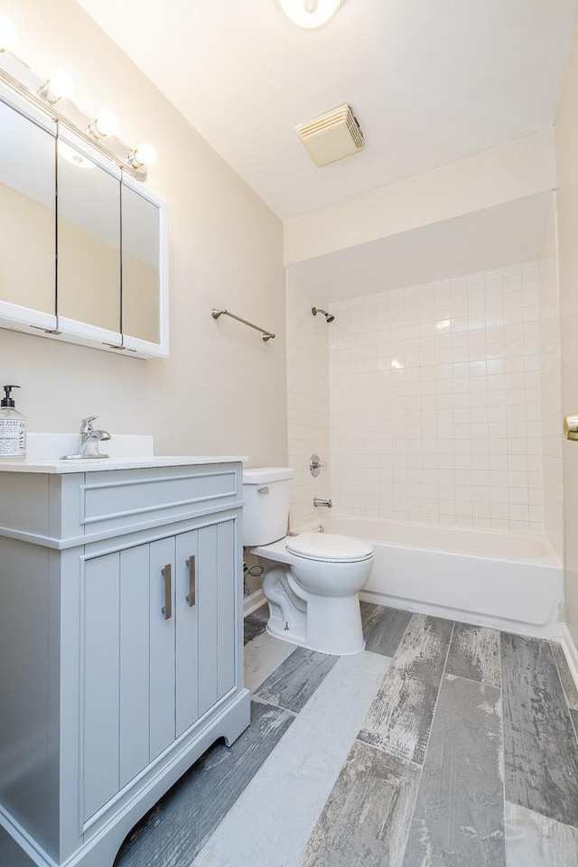 full bath featuring toilet, shower / tub combination, visible vents, and vanity