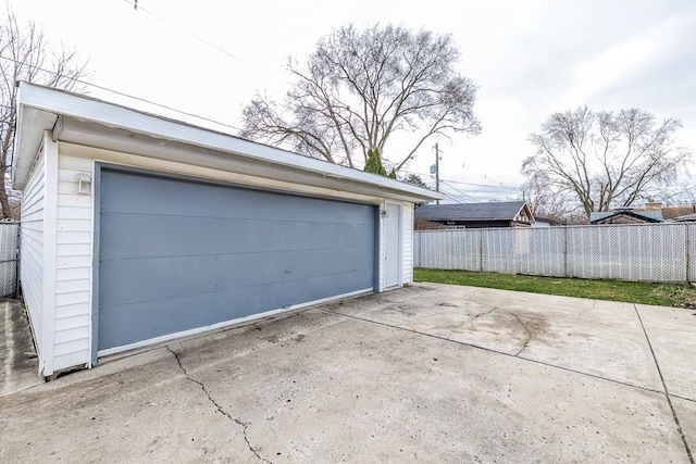 detached garage featuring fence