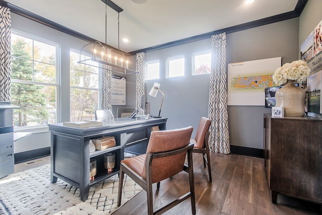 dining area featuring crown molding, wood-type flooring, and an inviting chandelier