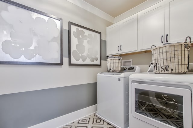 washroom with crown molding, cabinets, and washing machine and clothes dryer