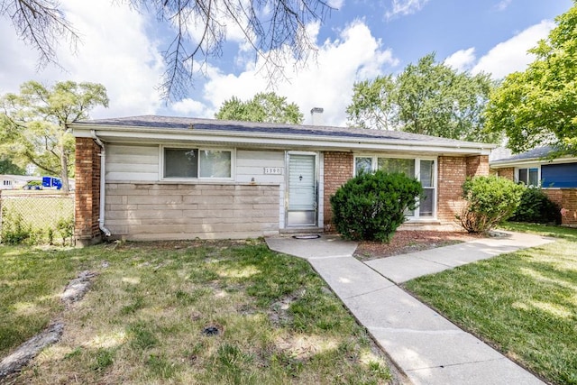 ranch-style house featuring brick siding, a front yard, and fence