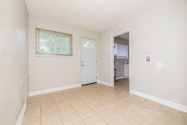 foyer entrance featuring light tile patterned floors and baseboards