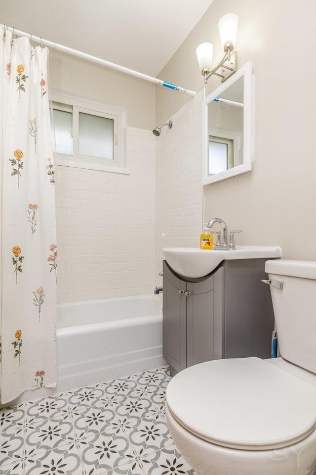 bathroom with a healthy amount of sunlight, vanity, toilet, and shower / bath combo with shower curtain