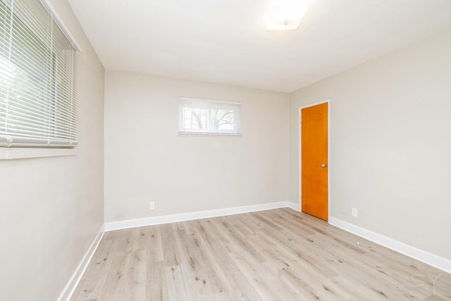 unfurnished room featuring light wood finished floors and baseboards