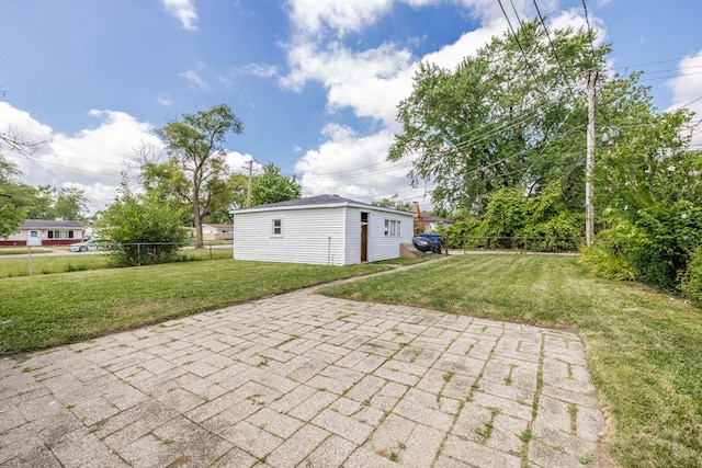 view of patio featuring an outdoor structure and fence private yard