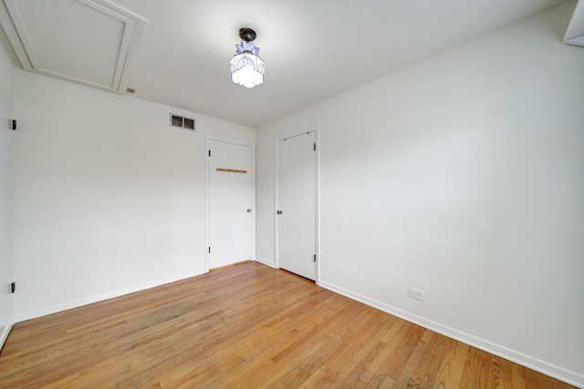 spare room with light hardwood / wood-style flooring