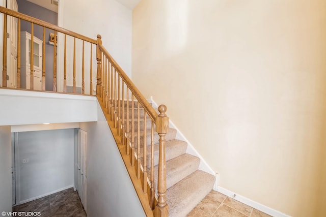 stairway featuring a high ceiling