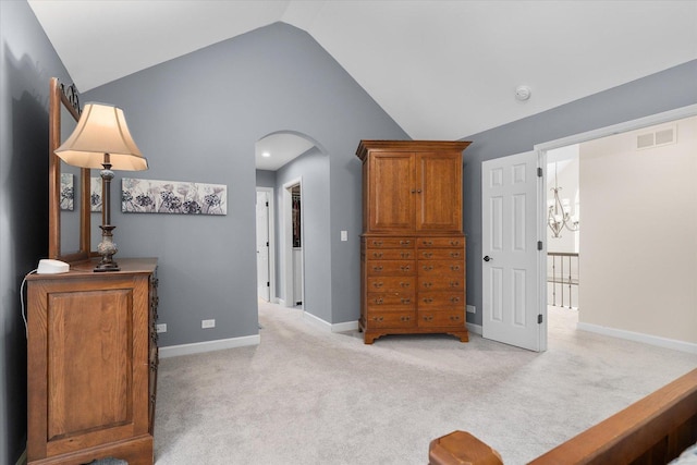 carpeted bedroom featuring lofted ceiling