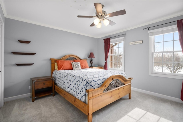 bedroom featuring ceiling fan, ornamental molding, and light carpet