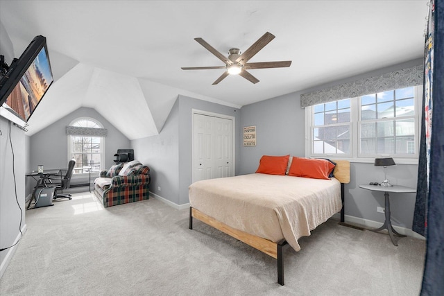 bedroom featuring a closet, vaulted ceiling, light colored carpet, and ceiling fan