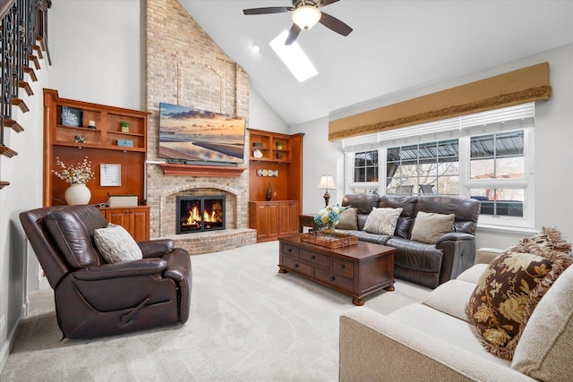 living room with high vaulted ceiling, ceiling fan, light colored carpet, and a fireplace