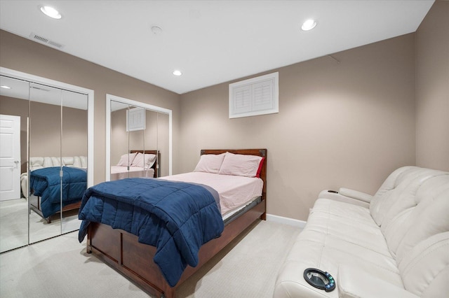 carpeted bedroom featuring multiple closets